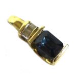 A 14ct gold, synthetic sapphire, and diamond pendant, the royal blue emerald cut synthetic sapphire,