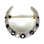 A 9ct gold, diamond and sapphire crescent moon brooch, the alternating stones of graduated size,