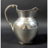 A Victorian silver water jug, of ovoid form, with double hinged lid, reeded handle with acanthus