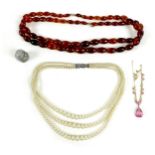 A small group of jewellery, comprising a clear amber bead necklace, a vintage pink stone and gold
