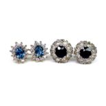 Two pairs of diamond cluster stud earrings, the first in silver with central deep blue sapphire, 1cm
