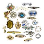 A group of costume brooches, including examples set with coloured stones, paste, and faux pearls, an