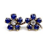 A pair of gold, sapphire and diamond flowerhead earrings, formed of five round cut royal blue