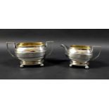 A George III silver twin handled sugar bowl and cream jug, the rectangular casket form bodies