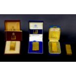 Four retro gold plated Dunhill cigarette lighters, comprising a Dunhill 70 lighter, with original