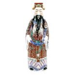 A Chinese porcelain figure, early 20th century, modelled as a man standing holding a ruyi sceptre,