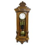 A 19th century Grand Sonnerie Vienna regulator wall clock, with three weights, pendulum and key