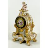 A French porcelain mantel clock, mid 19th century, of Rococo design with a cherub surmount,
