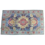 A Fine Tabriz rug with pale blue ground, central red flower shaped medallion sit upon a cream field,