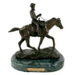 A modern replica bronze sculpture, circa 1990, modelled as a cowboy riding a horse, after the