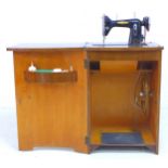 A vintage BSM (British Sewing Machines Ltd) treadle powered Type 3a, housed within a walnut veneered
