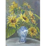 A 20th century still life of sunflowers in a blue and white vase, oil on canvas, signed 'Erica Eske'