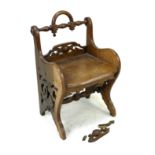 A Victorian oak hall chair, with handle to top of the pierced back rail and sides., 47.5 by 44 by