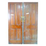A pair of four panelled stained pine doors, with Art Nouveau style brass handles to each door,