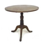 A George III oak tilt top occasional table, with circular top, turned column and tripod base, 79