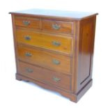 An Edwardian walnut chest of two short over three long graduating drawers, with brass plate handles,