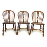 A group of five chairs, comprising a set of three 18th century oak Windsor side chairs, with pierced
