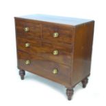 A Regency mahogany chest of two over two graduating drawers, with brass knobs, raised on later