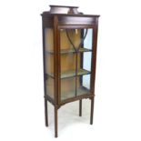 An Edwardian mahogany display cabinet, with inlaid decoration, single leaded glazed door enclosing