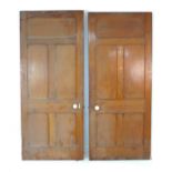 A pair of five panelled stained pine doors with ceramic round handles and escutcheons, 91 by 4 by