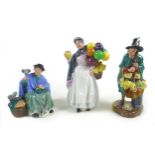 A group of three Royal Doulton china figurines, comprising 'The Mask Seller', HN2103, 21.5cm