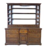 A George II oak dresser, the rack with three shelves above six short drawers flanked by