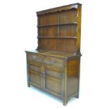 An Old Charm style stained oak dresser, carved decoration, with two shelf plate rack, two drawers