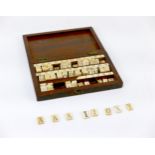 A 19th century John Calvert bone spelling alphabet with mahogany case, the case stamped 'Calvert 189
