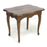 An Italian walnut side table, on cabriole legs with a shaped top, 73.5 by 56 by 58cm high.