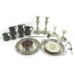 A group of silver plated items, including two pairs of candlesticks, wine coasters, three trays,