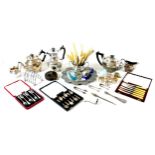 A group of silver plated items, including three teapots, flatware, a trays, flatware, and a toast
