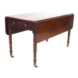 A large Regency mahogany Pembroke table, single frieze drawer with brass knob, opposing false drawer