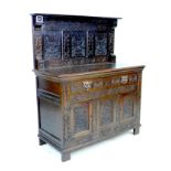 A Victorian stained oak sideboard, the front carved with green man face masks, blind friezes of