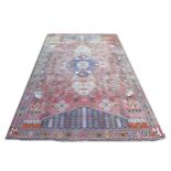 A Hamadan rug with red ground, floral decoration to the field, central dark blue geometric medallion