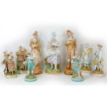 A group of nine large 19th century style bisque figurines, depicting ladies and gentleman in 18th/