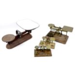 A collection of Victorian brass bell weights and weighing scales, including twenty-four bell weights