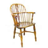 A Georgian oak and yew Windsor armchair, low rounded back with pierced splat and stick supports,