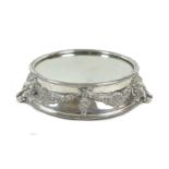 A mid 20th century silver plated wedding cake stand, of circular form, with mirrored centre