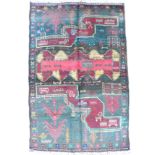 An Old Baluchi rug with green and black panelled ground, decorated with geometric motifs, with