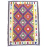 A Maimana Kilim rug with dark blue ground, with multiple colourful lozenges, with a cream and