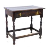 A 17th century oak side table, the rectangular surface above a single frieze drawer with brass