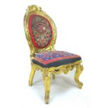 A French early 19th century giltwood chair, with medallion back, shell and foliate decoration,