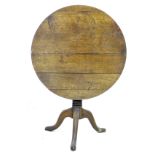 A George III oak tilt top occasional table, with circular top, turned column and tripod base, 79