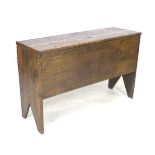 A 17th century oak coffer, with lift lid and sides descending to V cut-out supports, 102 by 34 by