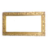 An Art Nouveau overmantel mirror, with bevelled rectangular plate, moulded gilt frame decorated with