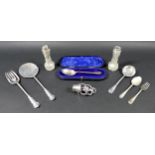 A small group of silver items, comprising a George V silver muffin slice and fork, Josiah Williams &