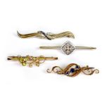 A group of four 9ct gold brooches, including one of Art Deco design with white stones in a white