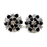 A pair of 9ct white gold, sapphire and diamond stud earrings, or cluster design set with deep blue