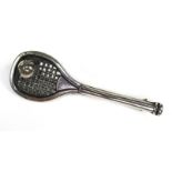 A white metal tennis racquet and ball tie pin, with pierced decoration to the racquet head,