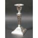 An ERII silver single candlestick, of stepped square section, with removable nozzle, decorated in